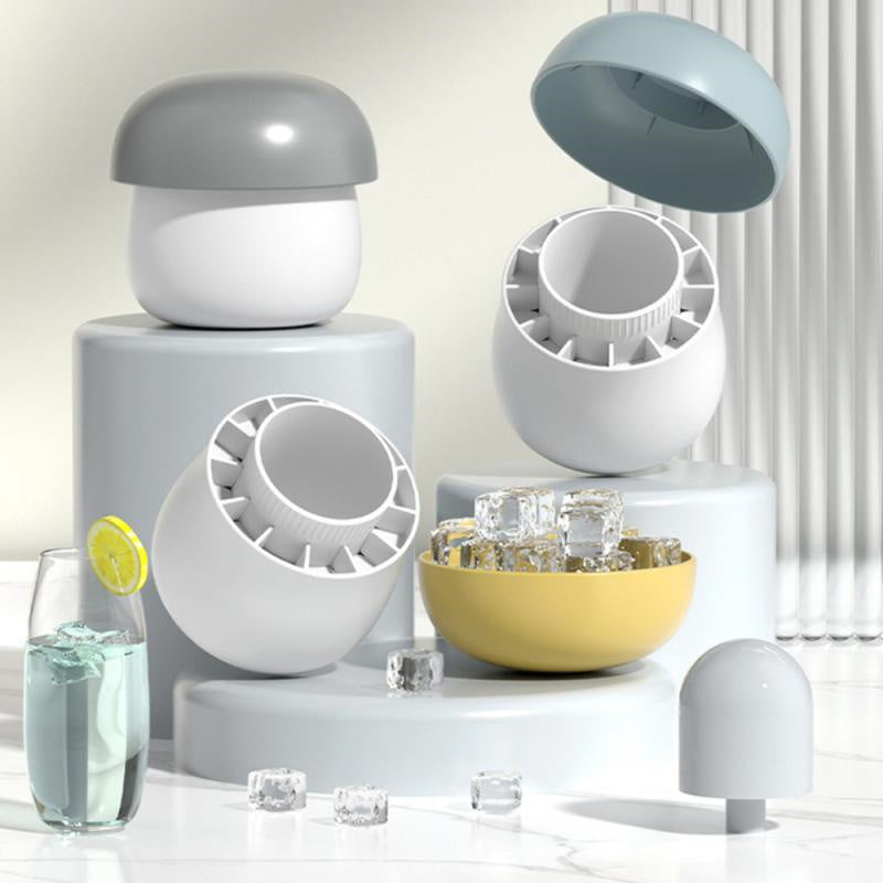 Modern kitchen appliances on a white surface with a glass of water and lemon.