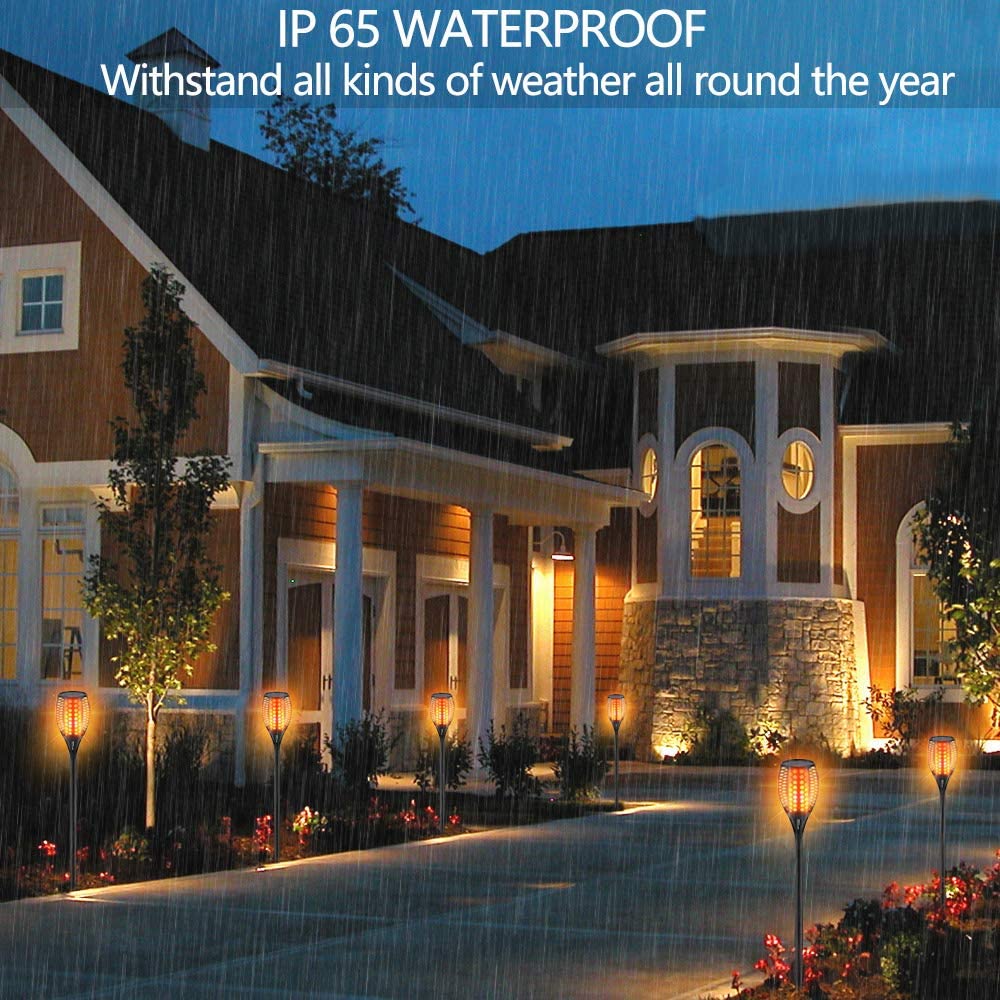 Stately home with outdoor lighting system during rain, emphasizing waterproof feature.