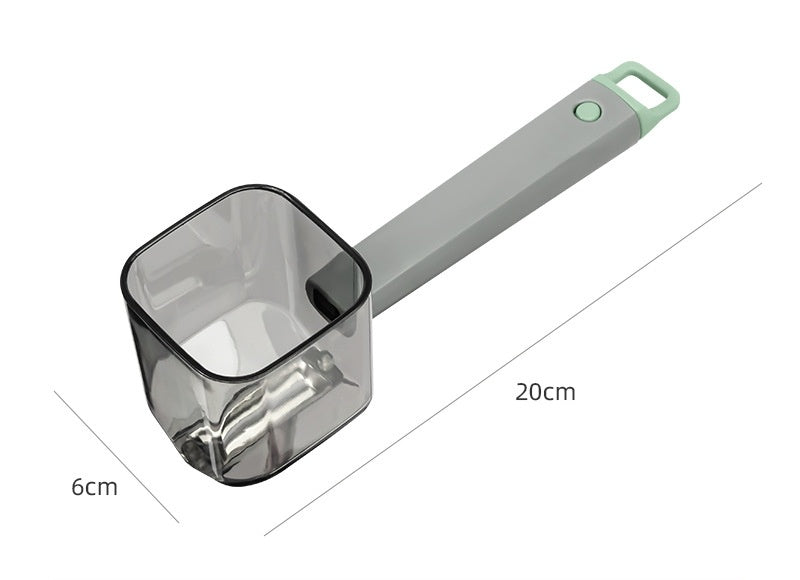 Measuring scoop with gray handle and clear container on a white background